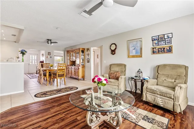 a living room with furniture and wooden floor