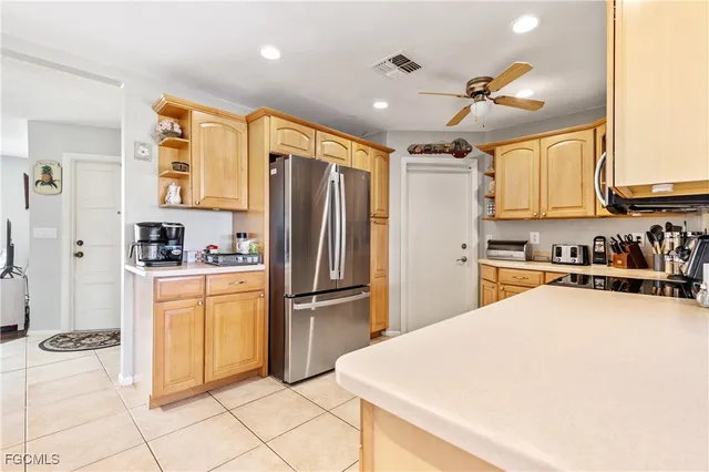 a kitchen with stainless steel appliances a refrigerator sink and cabinets