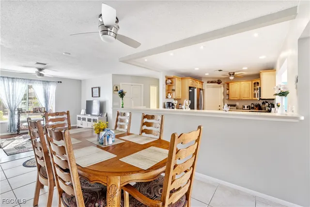 a view of a dining room with furniture and a chandelier