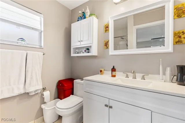 a bathroom with a toilet sink and mirror