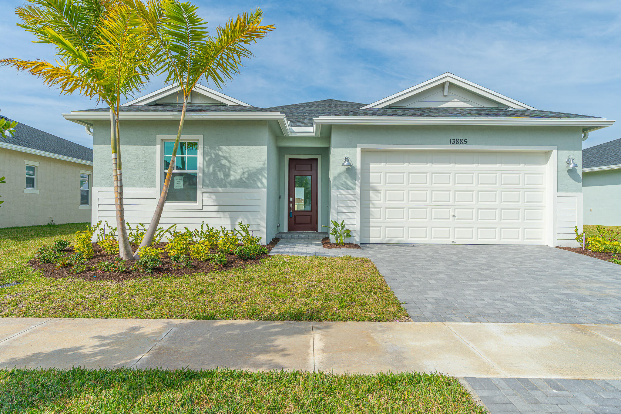 13885 Southeast Riversway St Port Port St. Lucie, FL 34984 - Photo 1 of 35 a front view of a house with garden