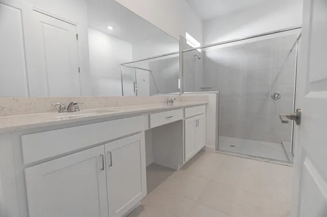 a spacious bathroom with a shower sink vanity and mirror