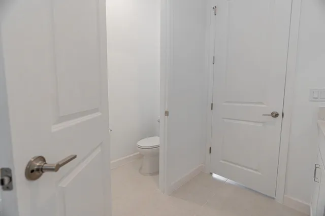 a bathroom with a granite countertop toilet and a shower