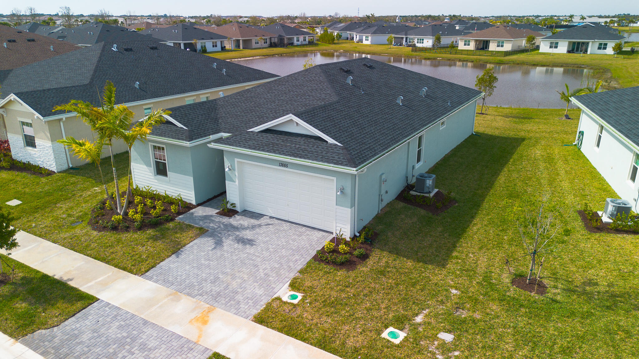 13885 Southeast Riversway St Port Port St. Lucie, FL 34984 - Photo 4 of 35 an aerial view of a house with a garden and lake view