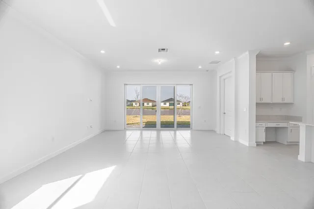 a view of an empty room with a kitchen