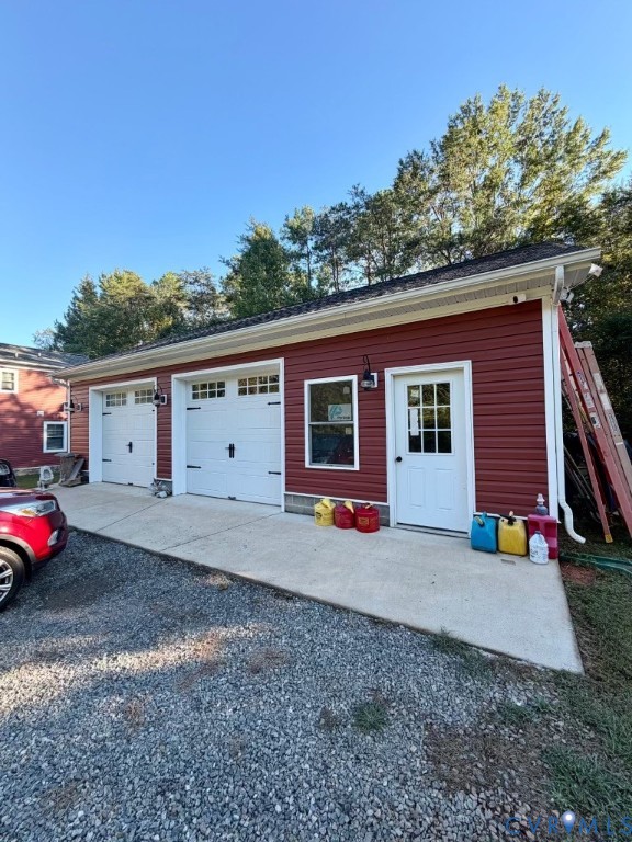 16233 Pleasant Mill Road Montpelier, VA 23192 - Photo 3 of 7 Red horizontal siding with a three-bay garage and