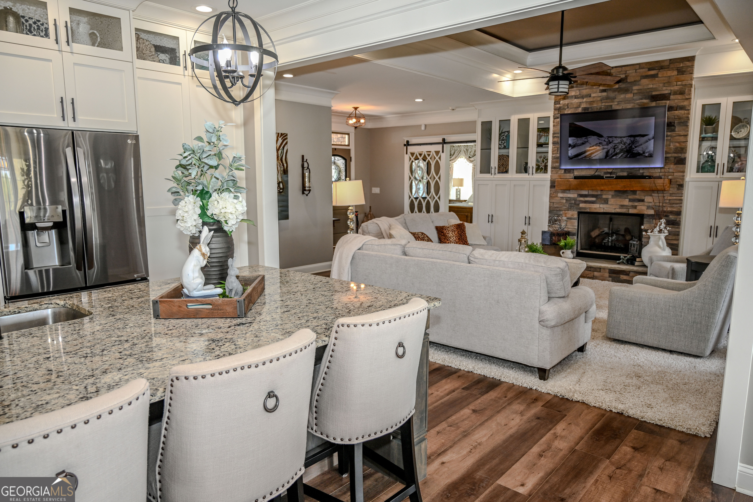 399 Overlook Trail Williamson, GA 30292 - Photo 13 of 52 a kitchen with stainless steel appliances granite countertop a kitchen island hardwood floor and a sink