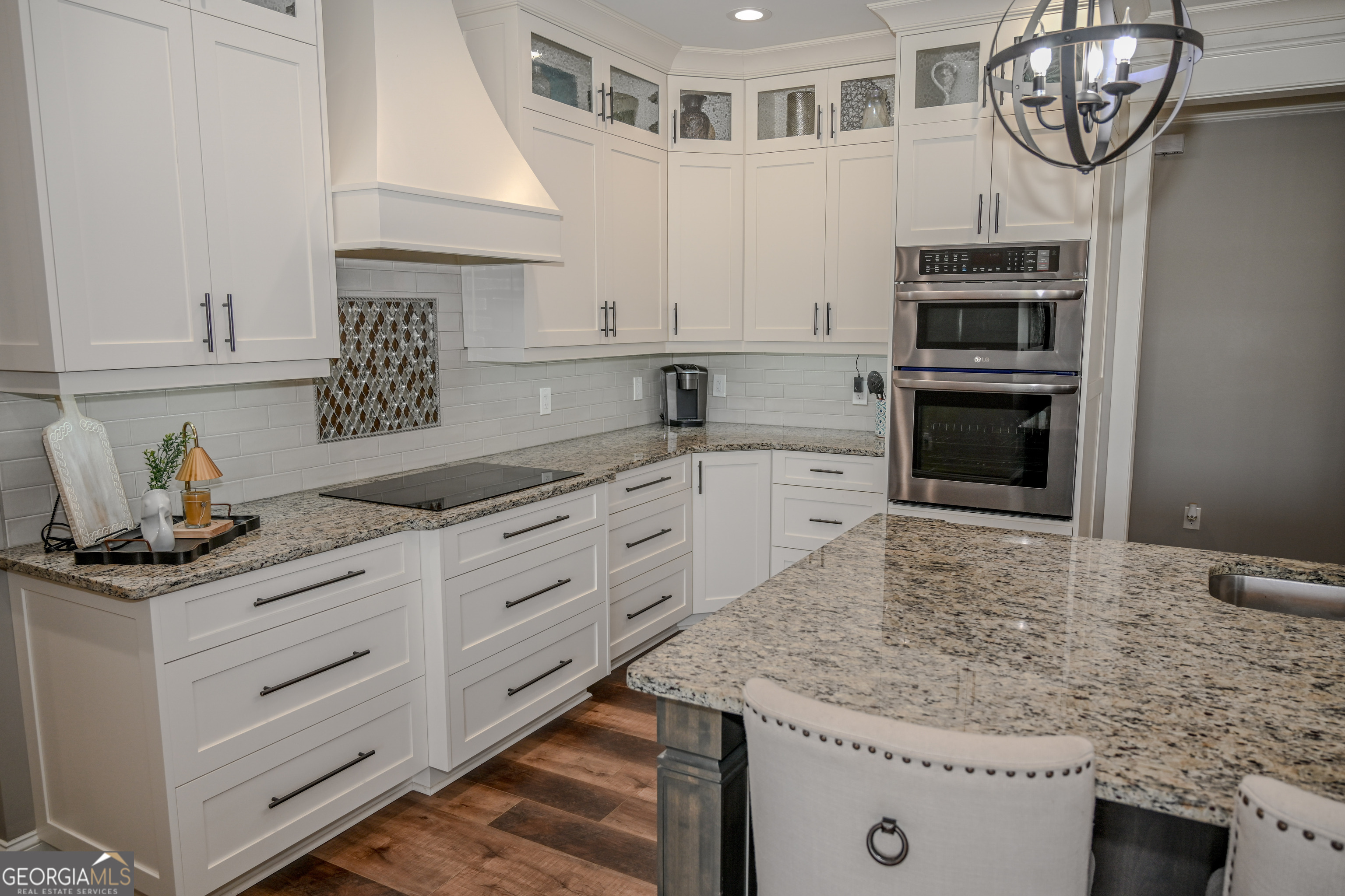 399 Overlook Trail Williamson, GA 30292 - Photo 14 of 52 a kitchen with granite countertop a sink a stove and cabinets