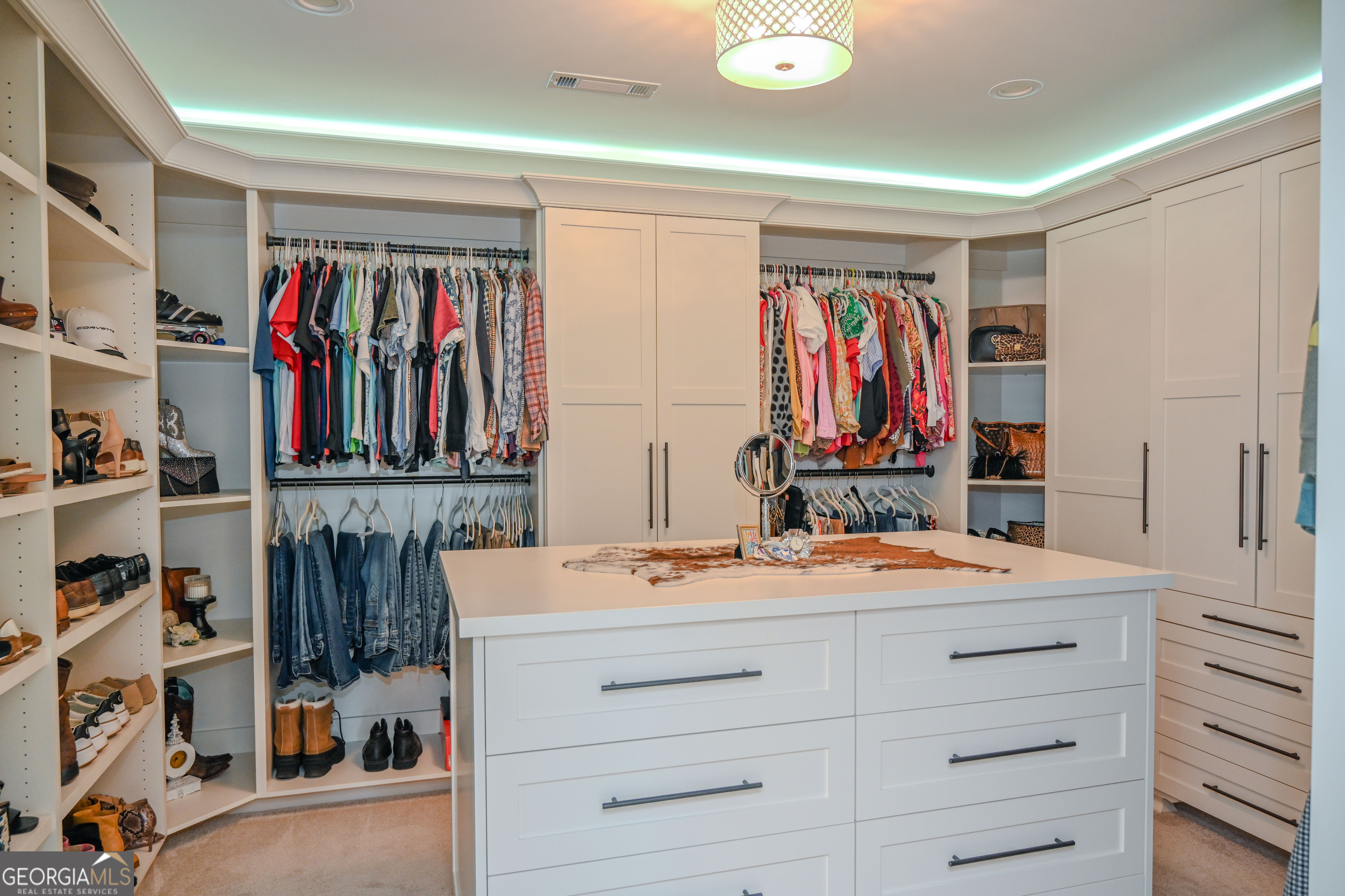 399 Overlook Trail Williamson, GA 30292 - Photo 26 of 52 a view of walk in closet with clothes and shoes