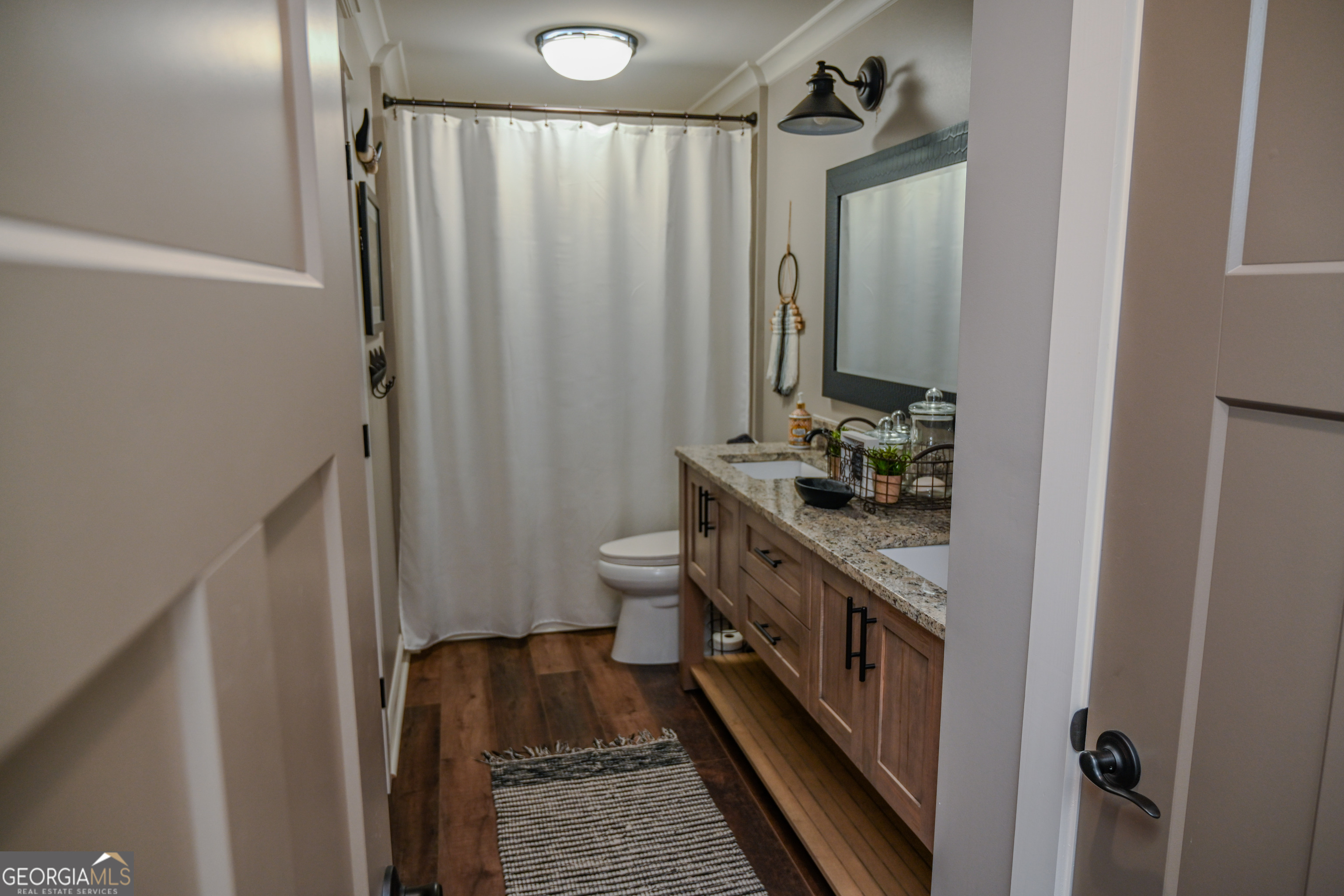 399 Overlook Trail Williamson, GA 30292 - Photo 42 of 52 a bathroom with a double vanity sink a toilet and a mirror