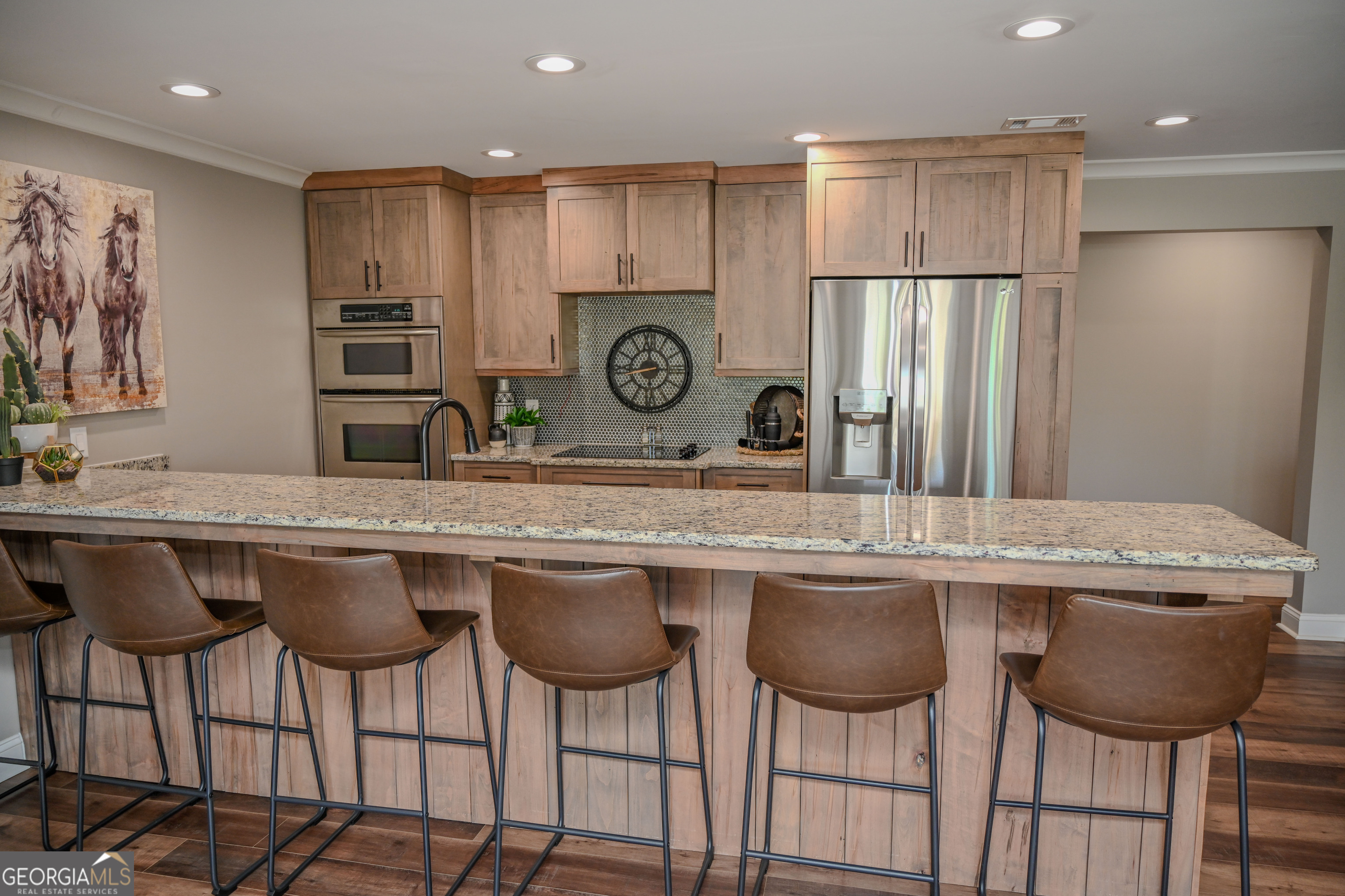 399 Overlook Trail Williamson, GA 30292 - Photo 46 of 52 a kitchen with stainless steel appliances granite countertop a table chairs sink and cabinets