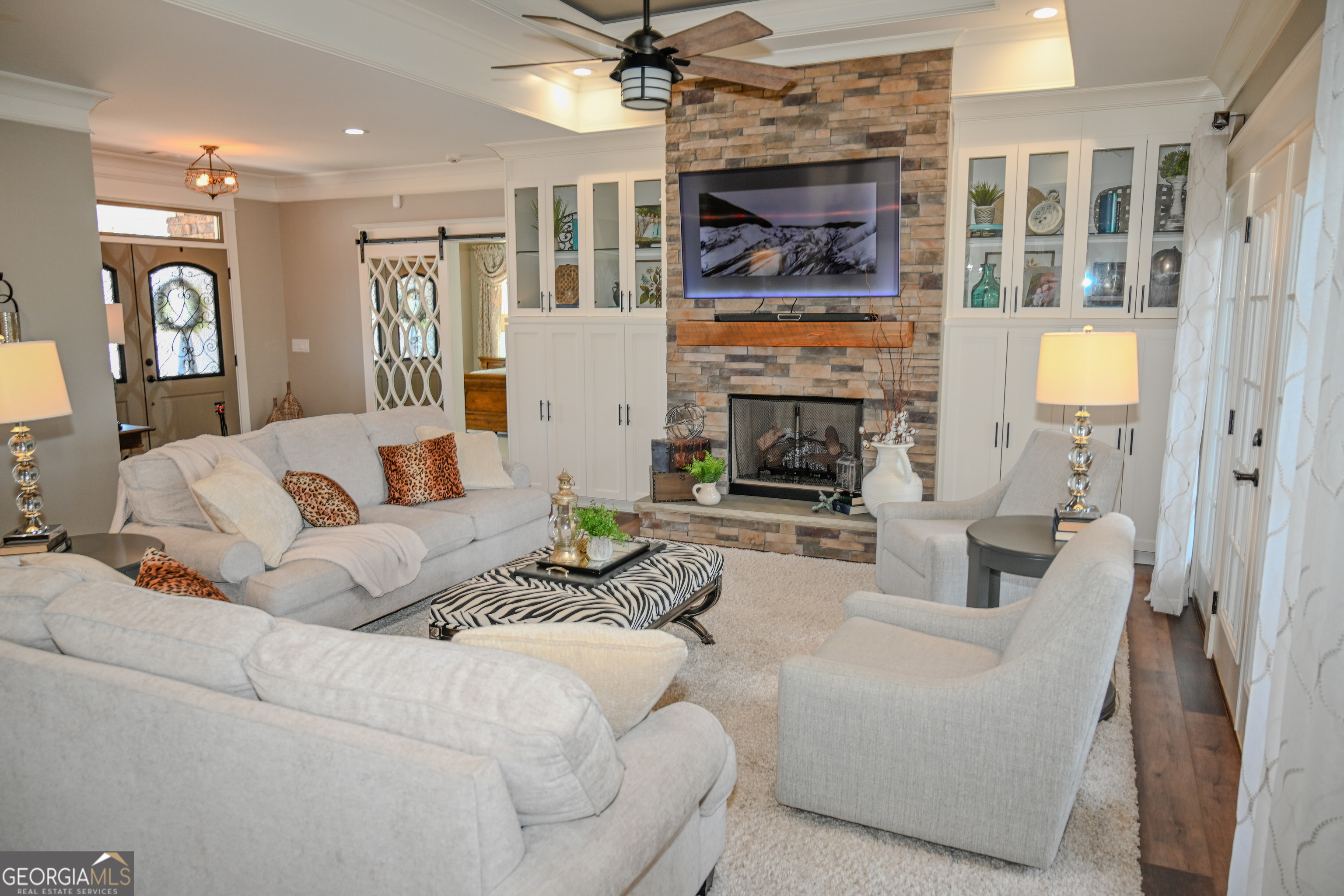 399 Overlook Trail Williamson, GA 30292 - Photo 6 of 52 a living room with furniture a fireplace and a flat screen tv