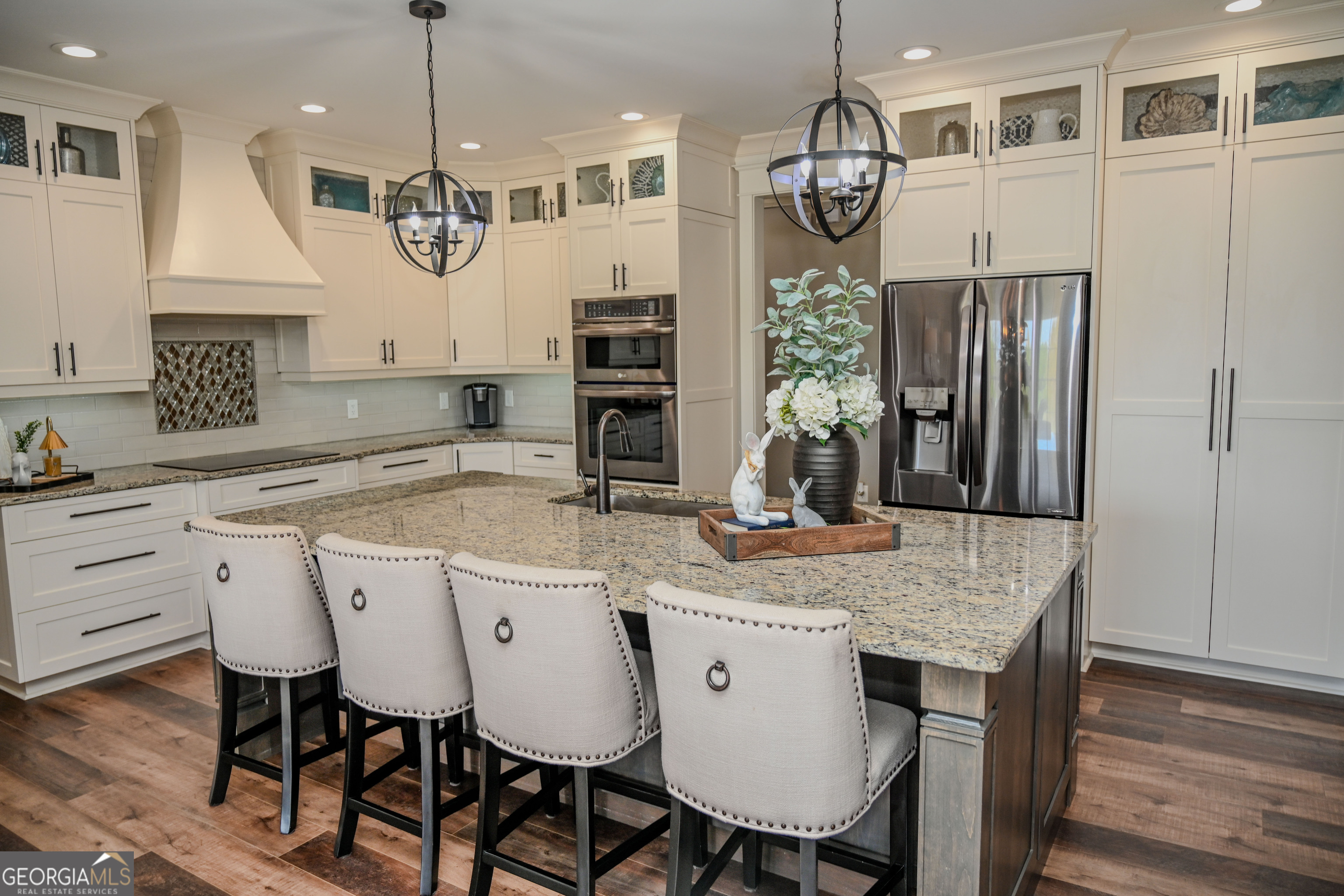 399 Overlook Trail Williamson, GA 30292 - Photo 7 of 52 a kitchen with a table chairs refrigerator and wooden floor