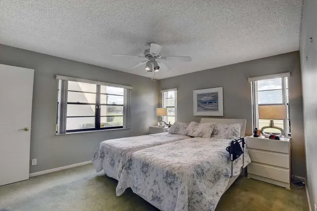 a spacious bedroom with a bed and a chandelier