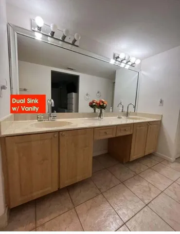 a room with kitchen island stainless steel appliances a sink and a counter top space