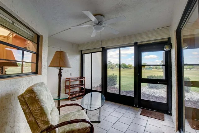 a living room with furniture and a floor to ceiling window