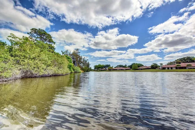 a view of a lake with houses in the background