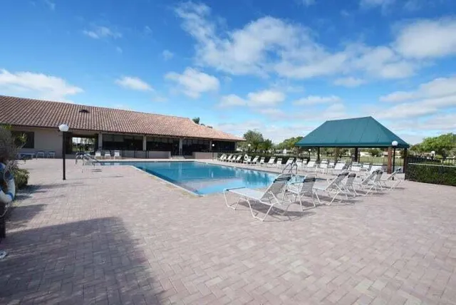 a view of a living room with furniture and floor to ceiling windows