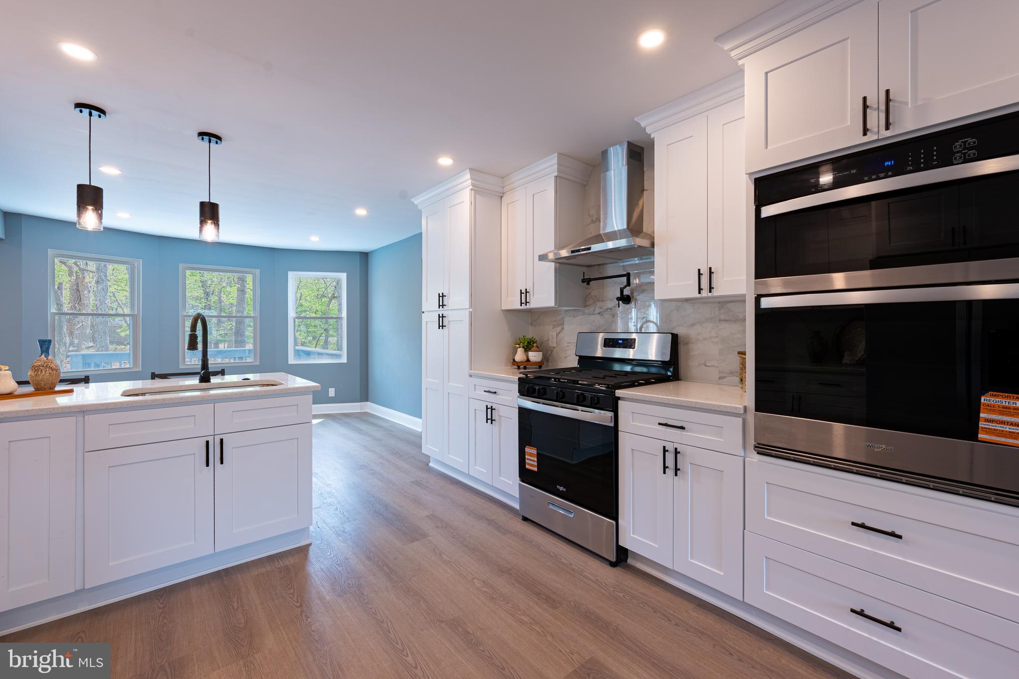 3 Slalom Court Pine Hill, NJ 08021 - Photo 6 of 47 a kitchen with stainless steel appliances kitchen island granite countertop a stove a sink and a microwave