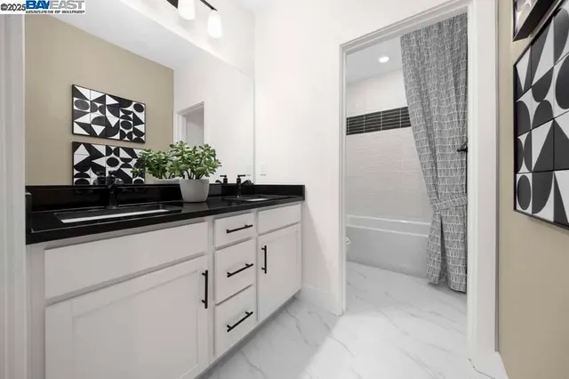 a bathroom with a sink a toilet a mirror and shower