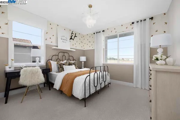a spacious bedroom with a bed and a window