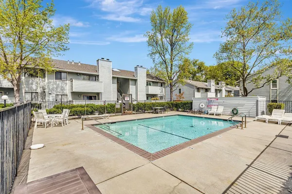 a view of a house with swimming pool and sitting area