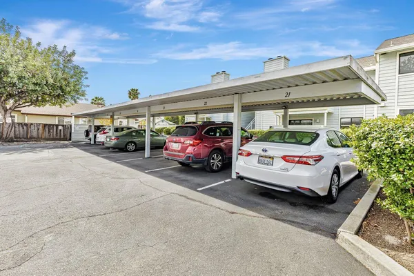 a view of a cars park in front of a building