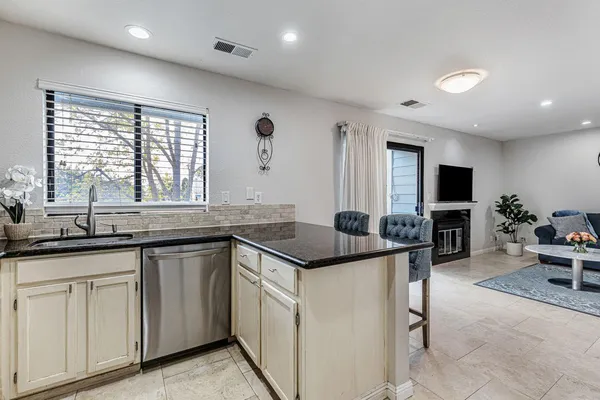 a kitchen with granite countertop a sink and cabinets