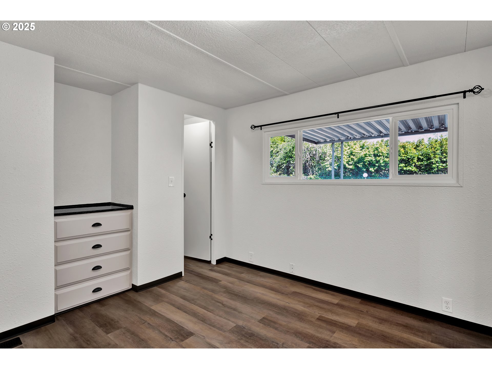 5055 Northeast Elliott Circle, Unit 8 Corvallis, OR 97330 - Photo 21 of 35 a view of room with window and hardwood floor