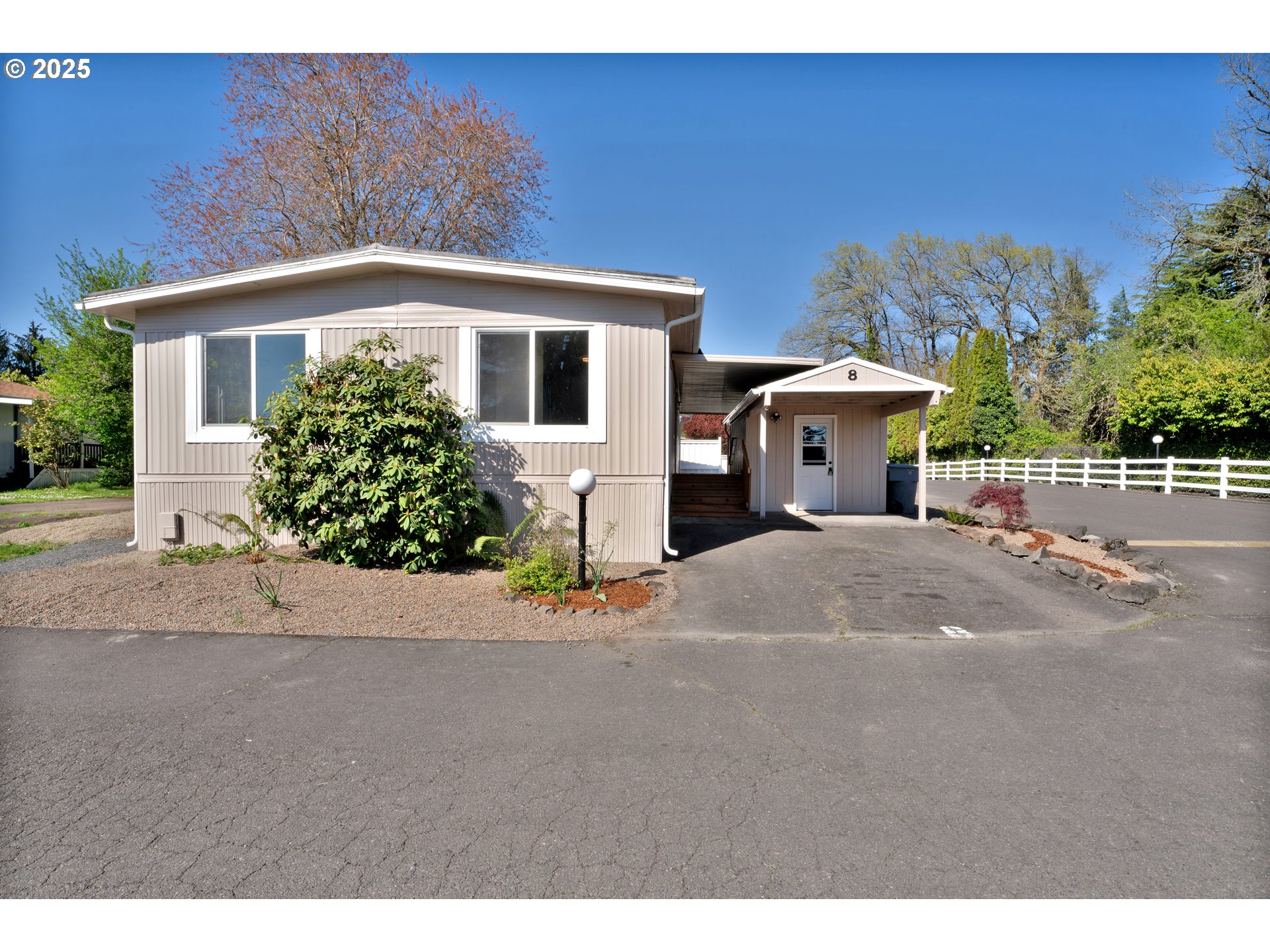 5055 Northeast Elliott Circle, Unit 8 Corvallis, OR 97330 - Photo 3 of 35 a front view of a house with a yard and garage