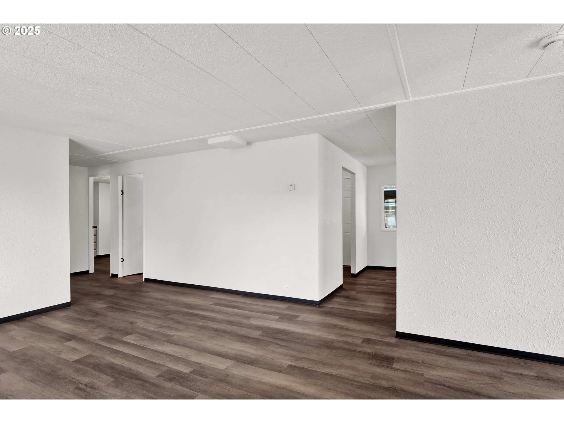 5055 Northeast Elliott Circle, Unit 8 Corvallis, OR 97330 - Photo 31 of 35 a view of an empty room with wooden floor