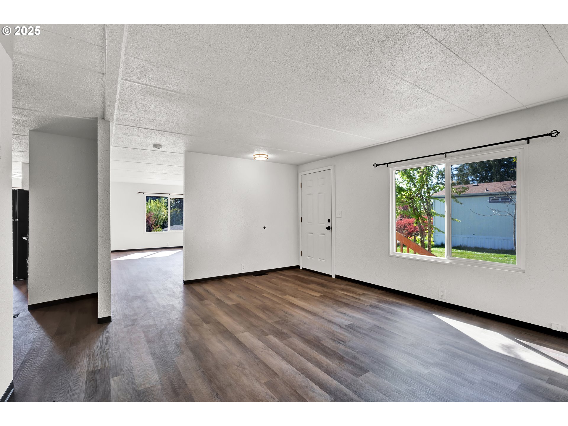 5055 Northeast Elliott Circle, Unit 8 Corvallis, OR 97330 - Photo 33 of 35 a view of an empty room with wooden floor and a window