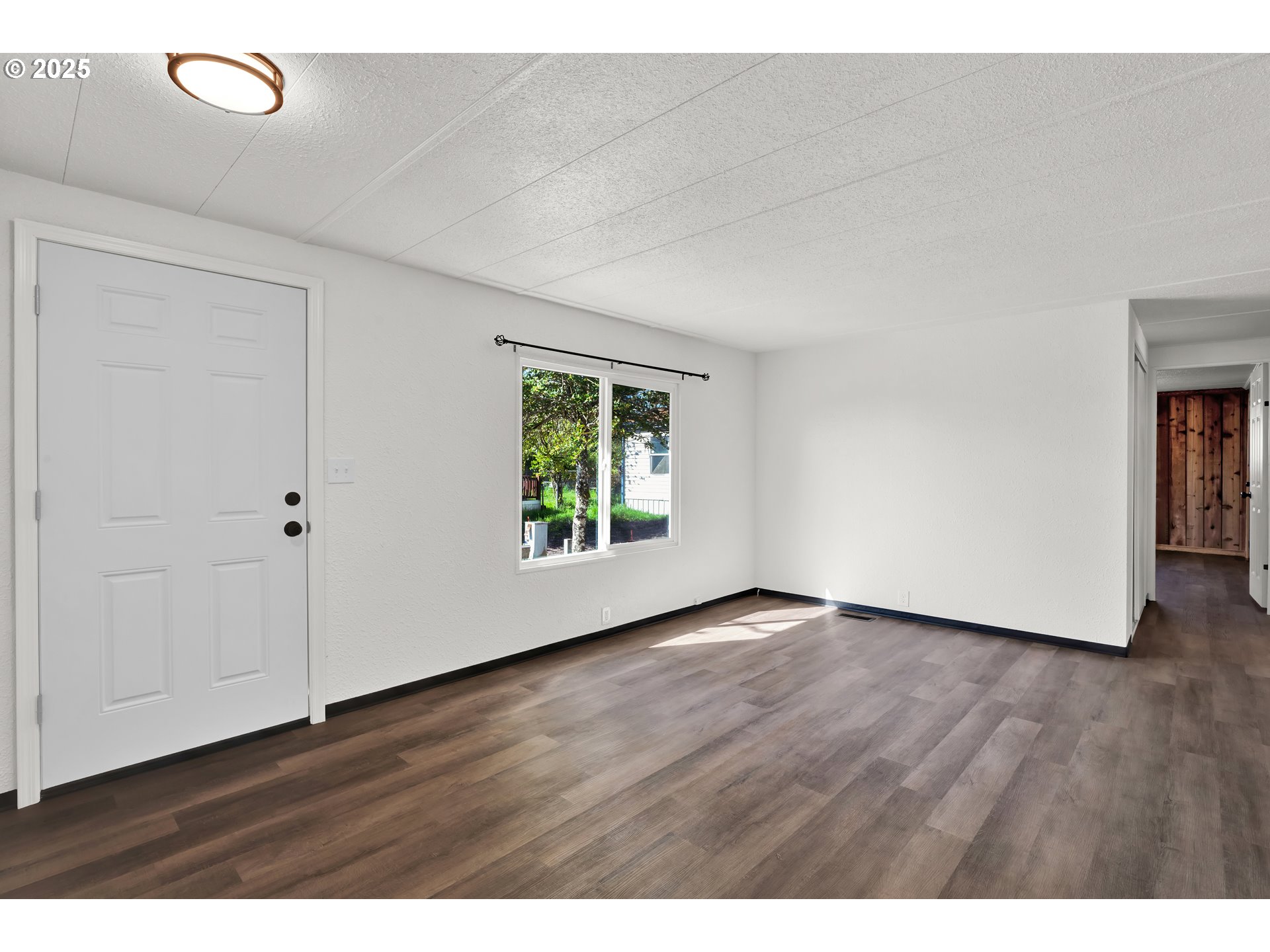 5055 Northeast Elliott Circle, Unit 8 Corvallis, OR 97330 - Photo 34 of 35 a view of an empty room with wooden floor and a window