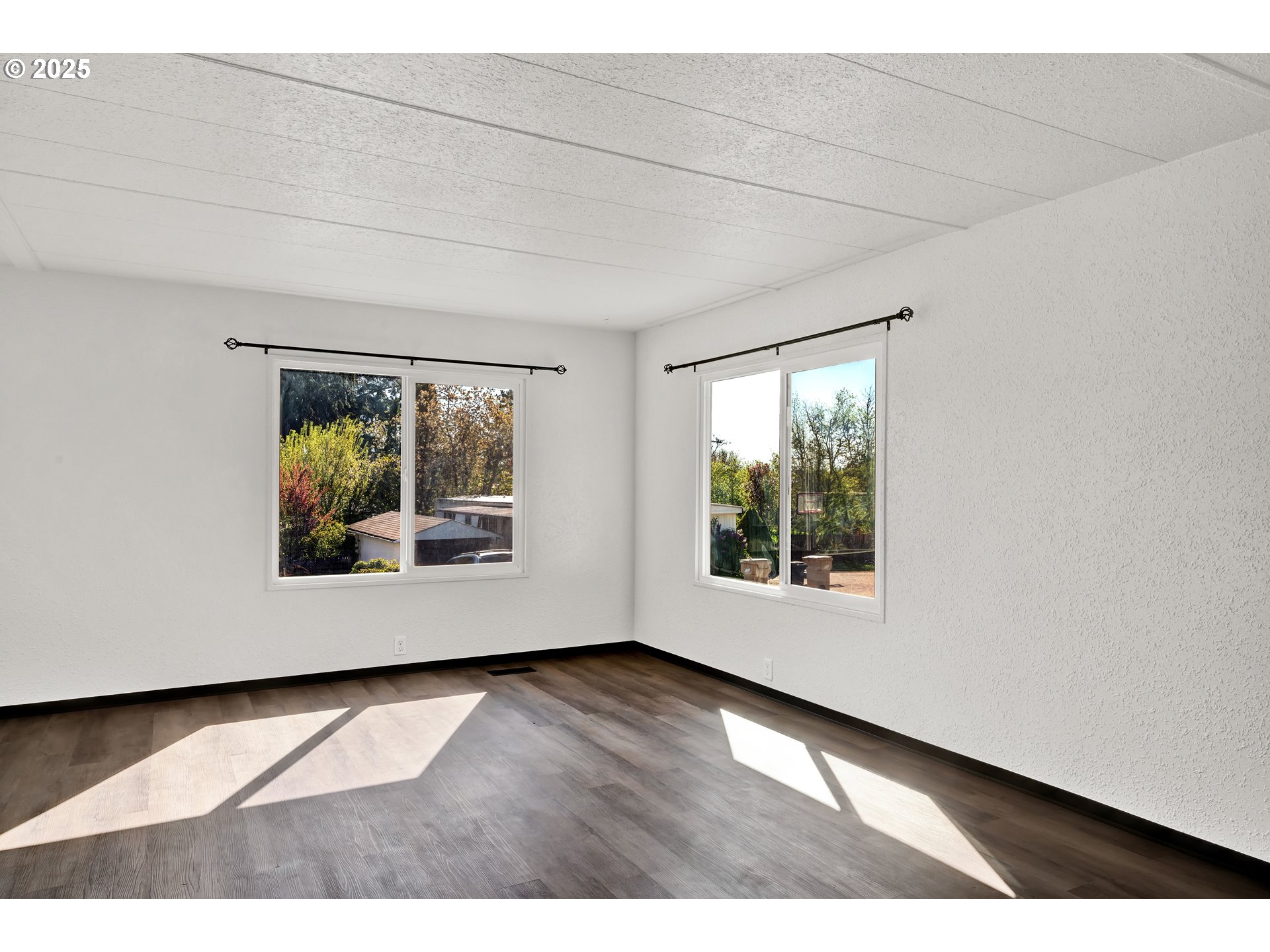 5055 Northeast Elliott Circle, Unit 8 Corvallis, OR 97330 - Photo 35 of 35 an empty room with wooden floor and windows