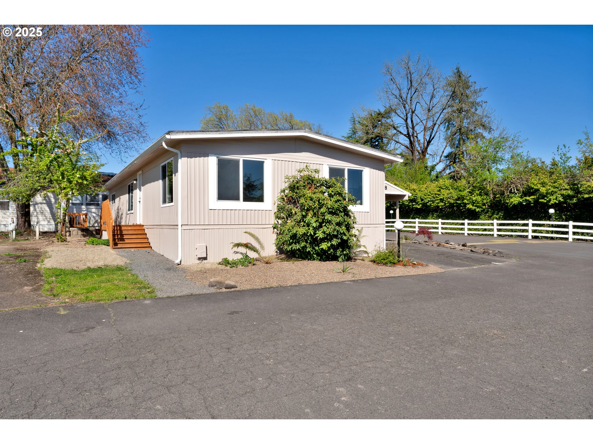 5055 Northeast Elliott Circle, Unit 8 Corvallis, OR 97330 - Photo 4 of 35 a front view of a house with a yard and garage