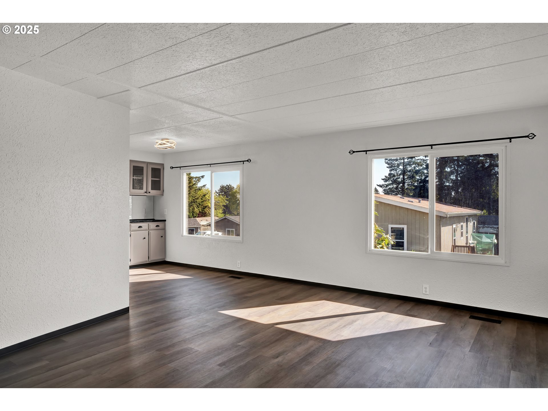 5055 Northeast Elliott Circle, Unit 8 Corvallis, OR 97330 - Photo 5 of 35 a view of an empty room with a window and wooden floor