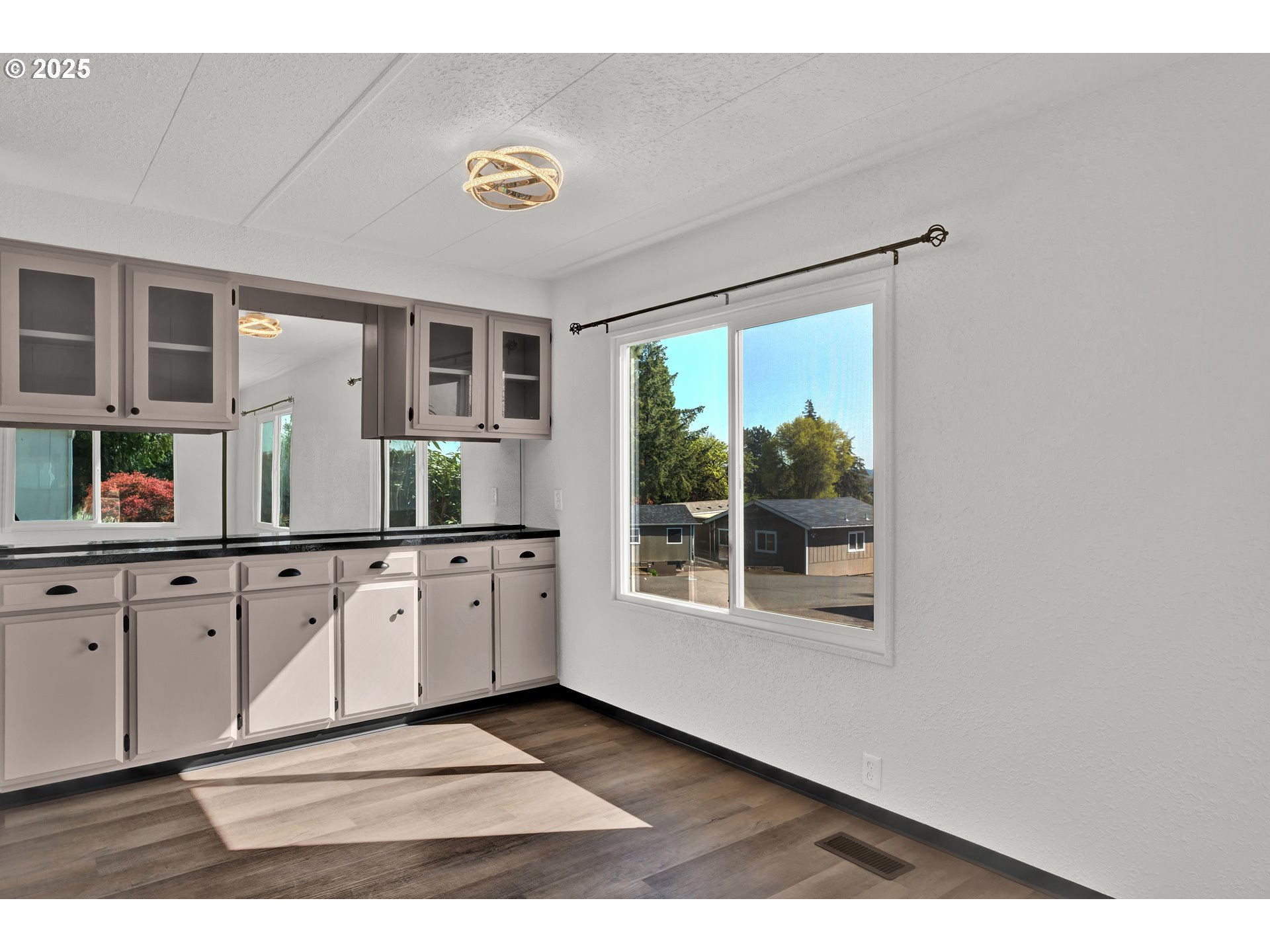 5055 Northeast Elliott Circle, Unit 8 Corvallis, OR 97330 - Photo 8 of 35 a view of a kitchen with granite countertop cabinets and a large window