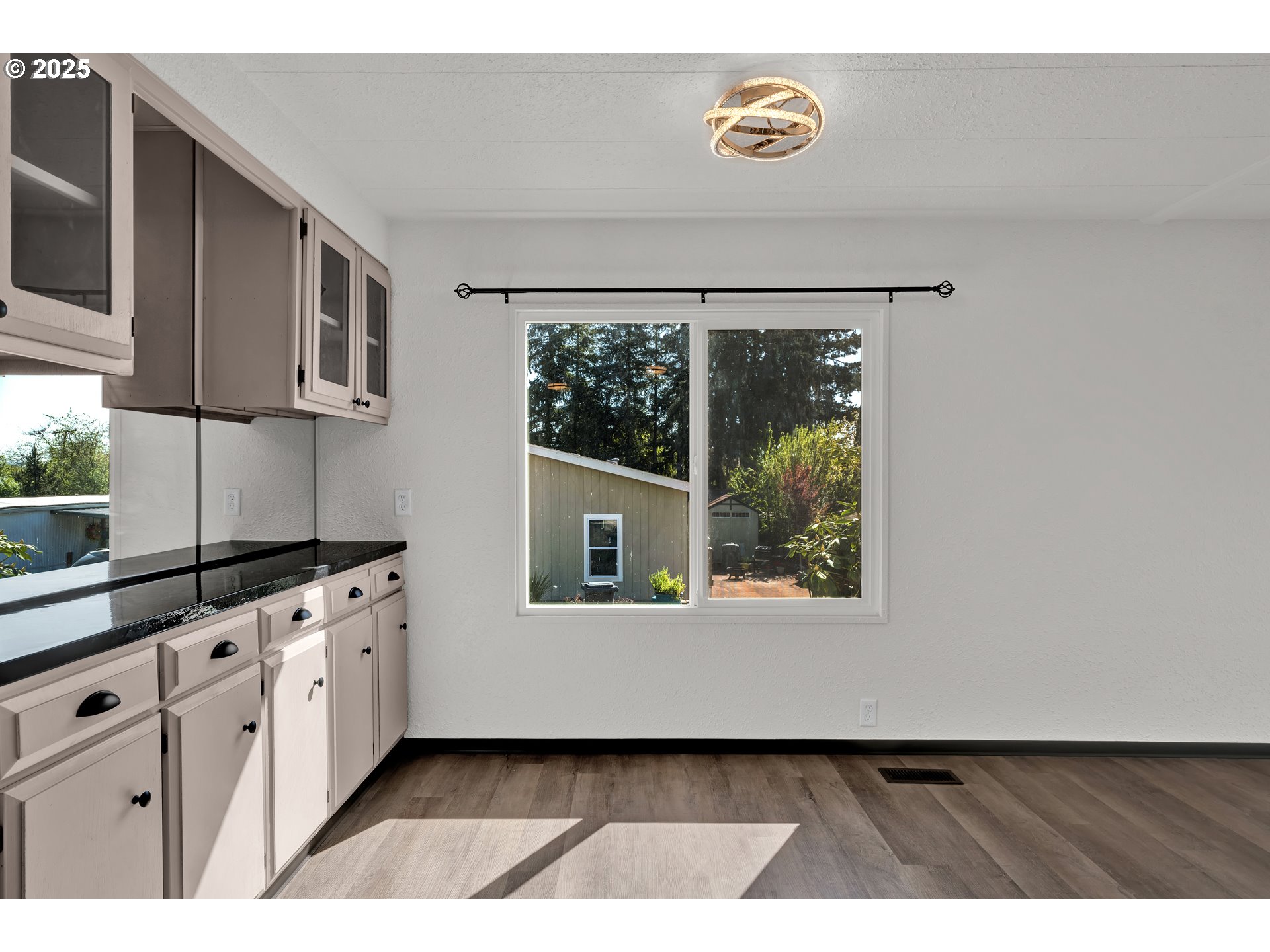 5055 Northeast Elliott Circle, Unit 8 Corvallis, OR 97330 - Photo 9 of 35 a kitchen with white cabinets a window and a potted plant
