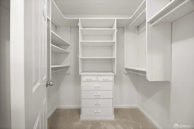 a spacious bathroom with a granite countertop sink toilet and a mirror