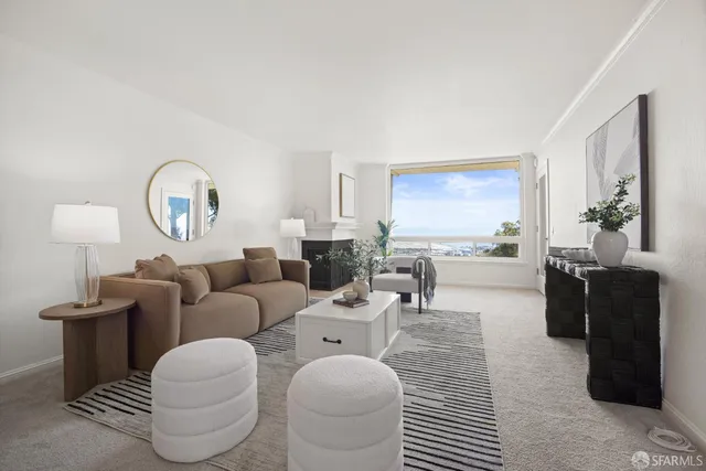 a living room with furniture a fireplace and kitchen view