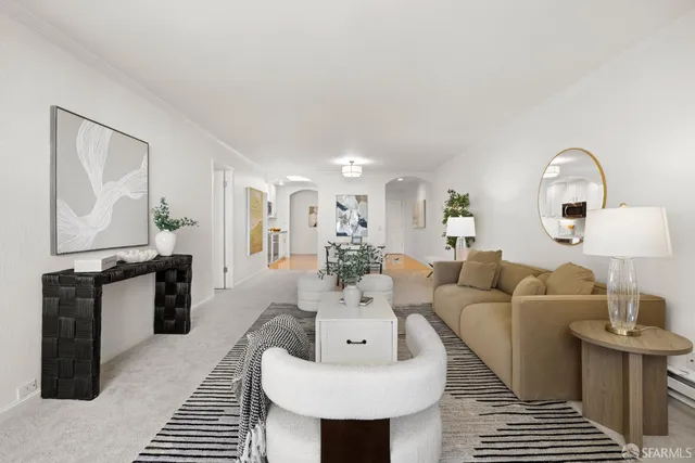 a view of a livingroom with furniture and a potted plant