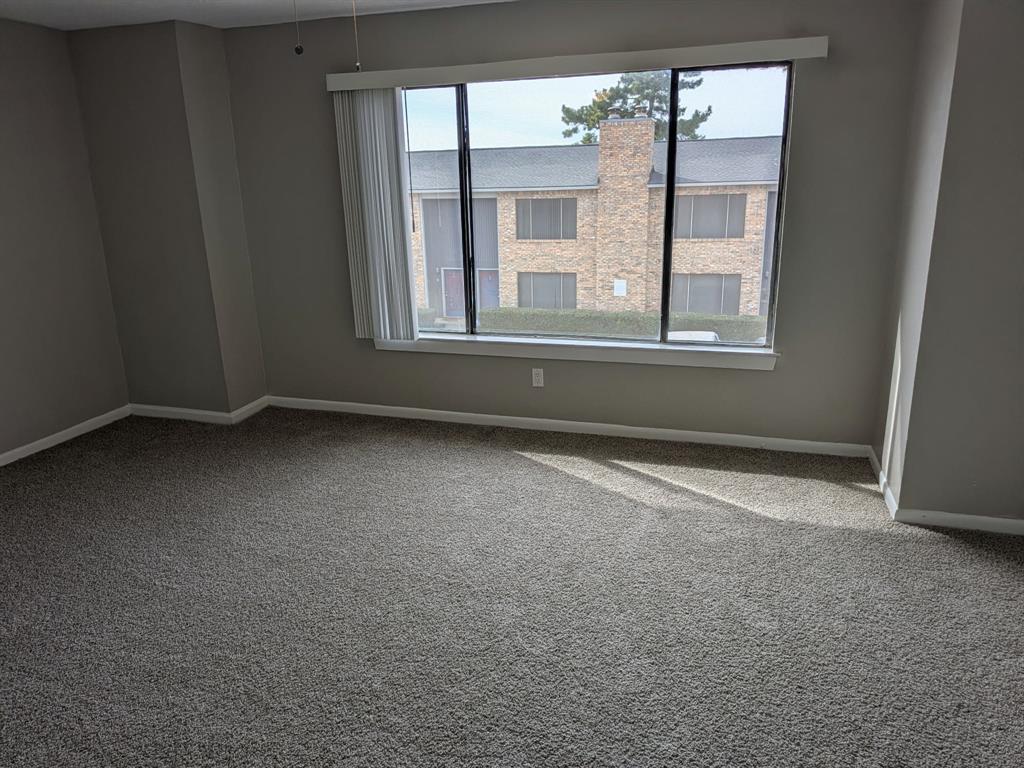 514 East Belt Line Road, Unit B13 DeSoto, TX 75115 - Photo 17 of 28 an empty room with windows and chandelier