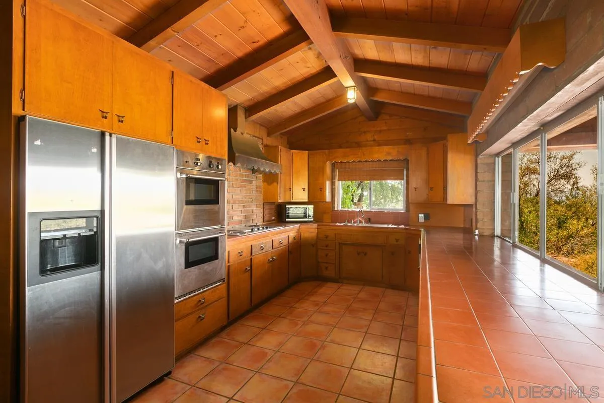 32630 Camino Moro Warner Springs, CA 92086 - Photo 15 of 33 a kitchen with cabinets and stainless steel appliances