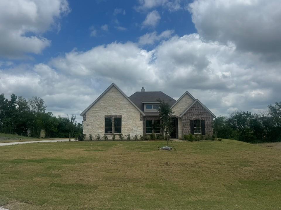 a front view of house with yard and green space