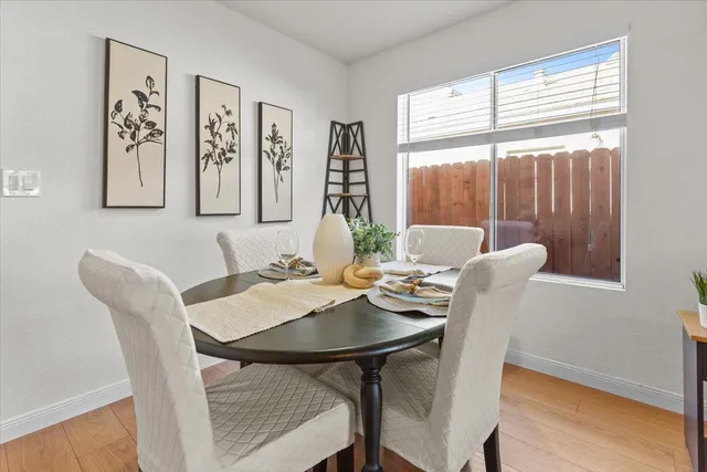 a view of a dining room with furniture window and wooden floor