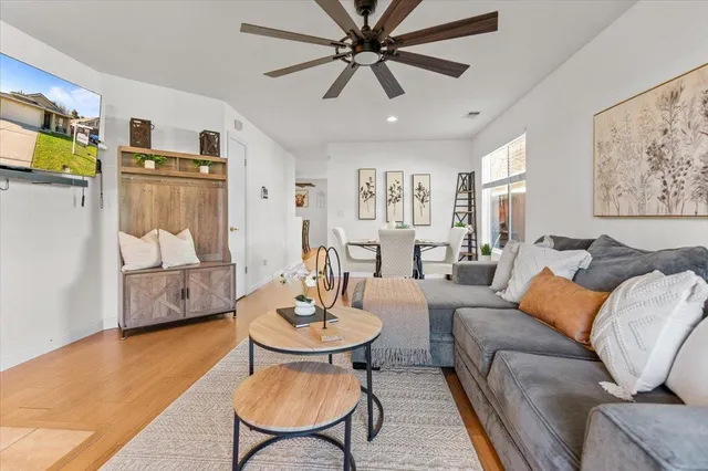 a living room with furniture and a chandelier
