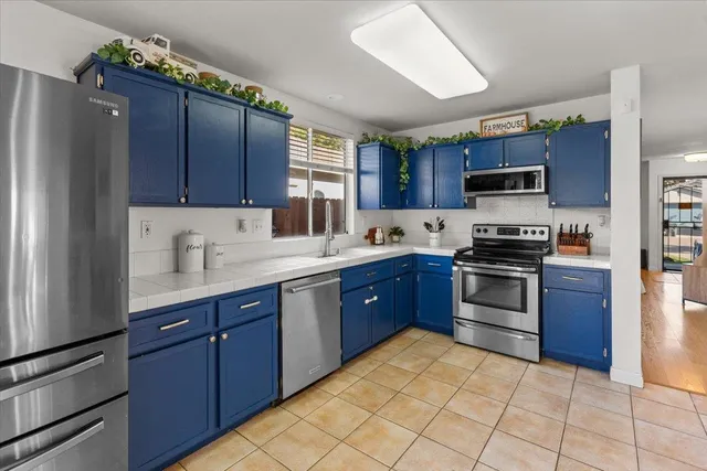 a kitchen with stainless steel appliances granite countertop a refrigerator stove and sink