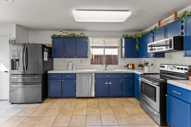 a kitchen with stainless steel appliances granite countertop a stove a sink dishwasher a refrigerator and a microwave oven