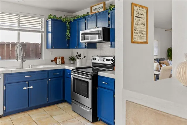 a kitchen with stainless steel appliances granite countertop a sink stove and microwave