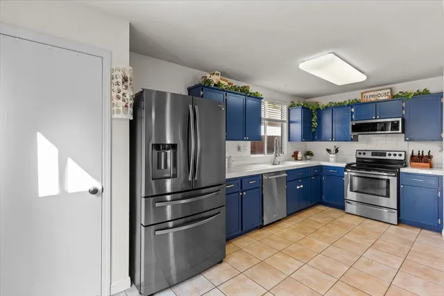 a kitchen with stainless steel appliances granite countertop a refrigerator stove and sink